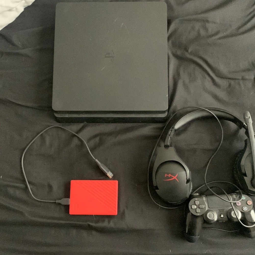 PlayStation 4 with a 1 TB hard drive, 1 controller that comes with charging cord